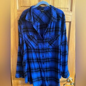Long sleeve black and blue plaid shirt. Cut out on shoulders.